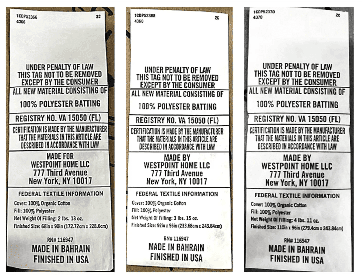 Three narrow vertical labels or tags showing the same printed text block, photographed against a dark background. The text reads 'UNDER PENALTY OF LAW THIS TAG TO BE REMOVED EXCEPT BY THE CONSUMER' and includes manufacturer and country-of-origin details such as 'Made for Westpoint Home LLC' and 'Finished in Bahrain.
