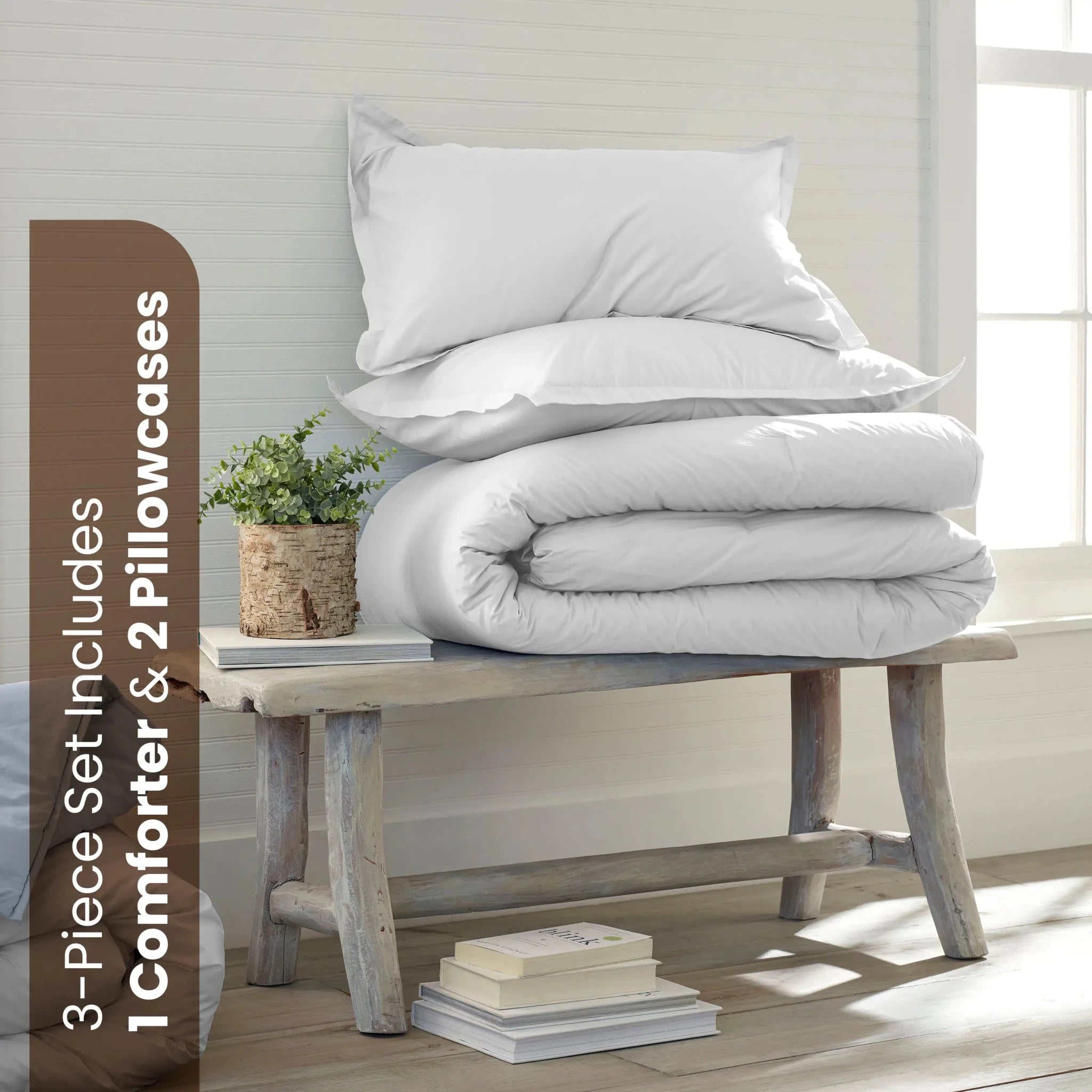 White comforter and pillows in a neutral background. The set includes a folded white comforter and two white pillowcases.