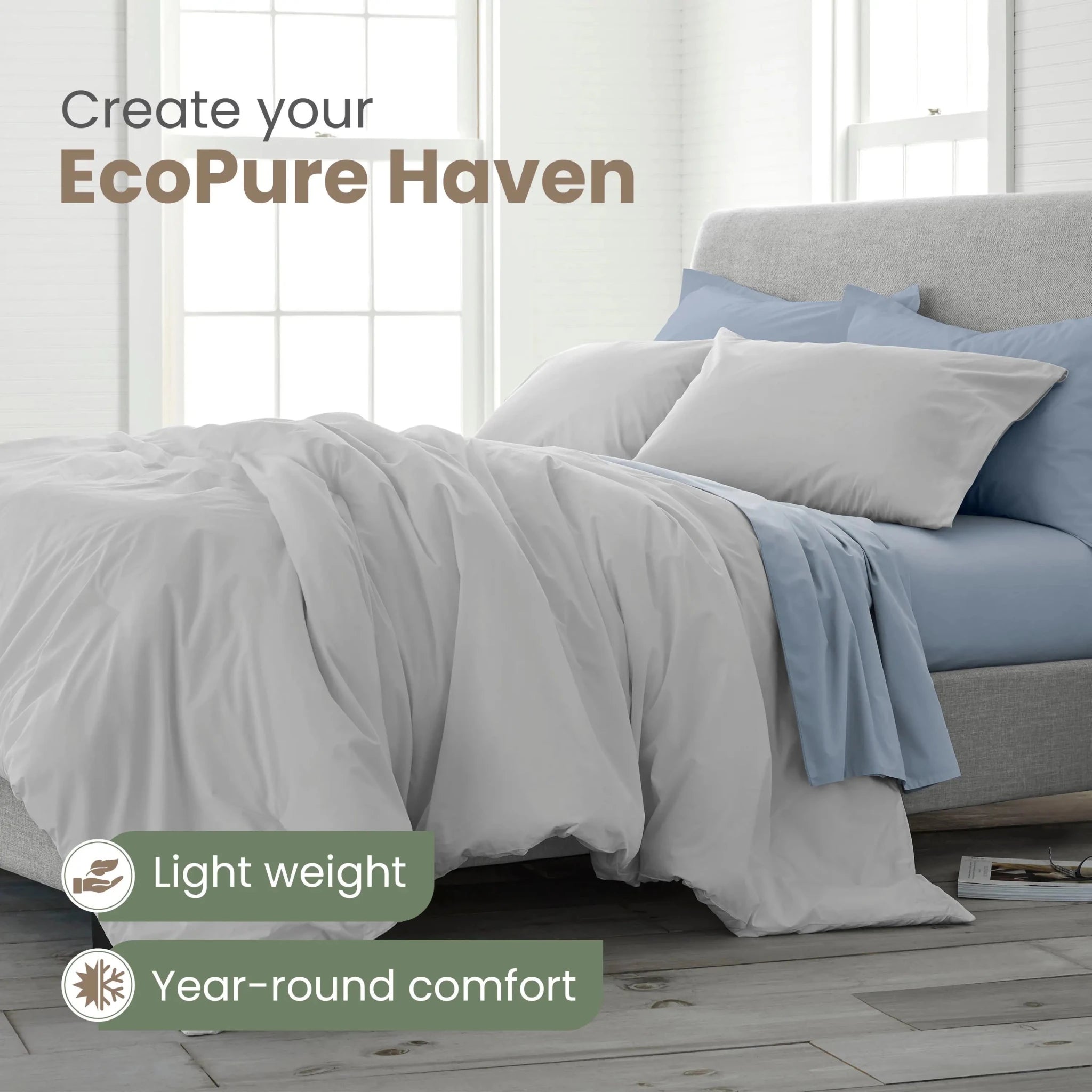 A neatly made bed in a bright bedroom setting, shown with a light gray comforter and pillowcases, and light blue sheets. Text on the image reads 'Create your EcoPure Haven' and includes callout badges for 'Light weight' and 'Year-round comfort'.