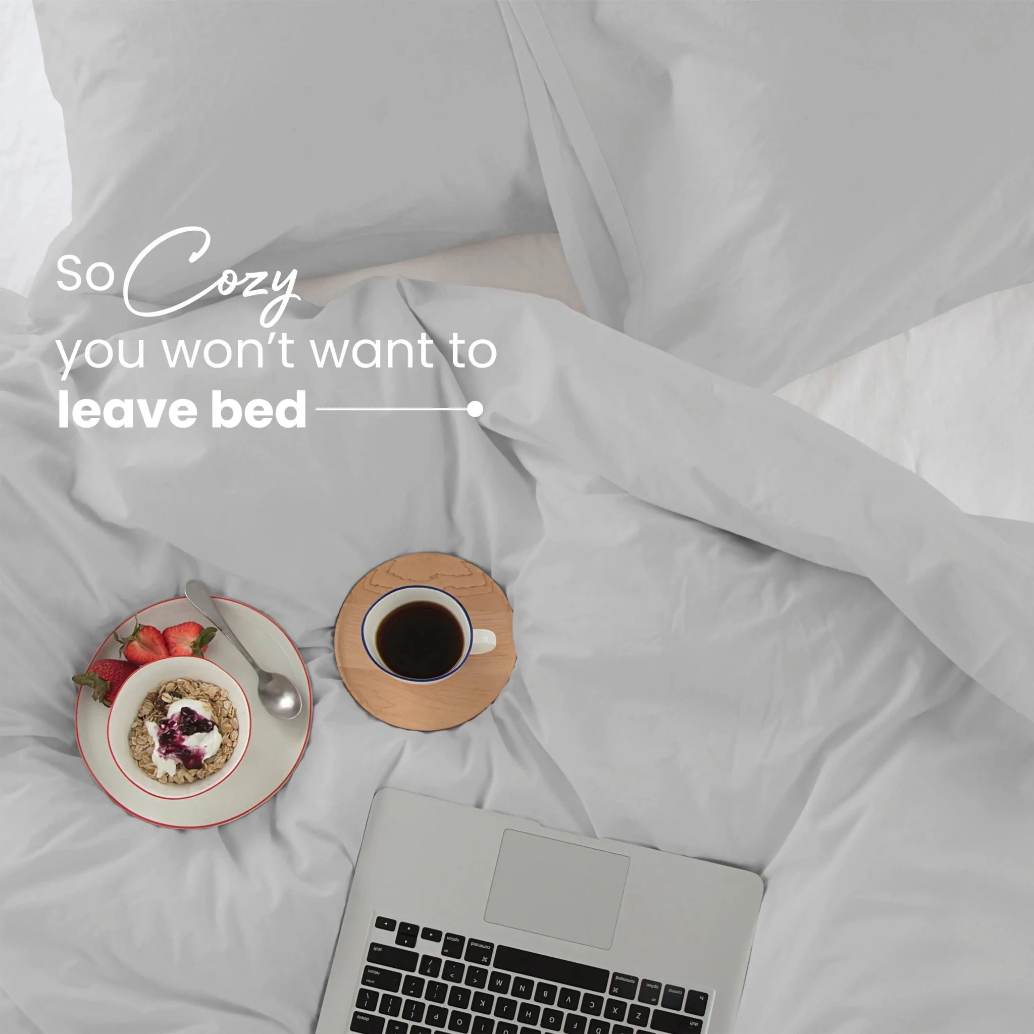 Cozy light grey bedding, with text 'So Cozy you won't want to leave bed'.