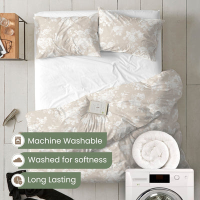 Floral comforter set on a bed with washing machine and dryer in the background