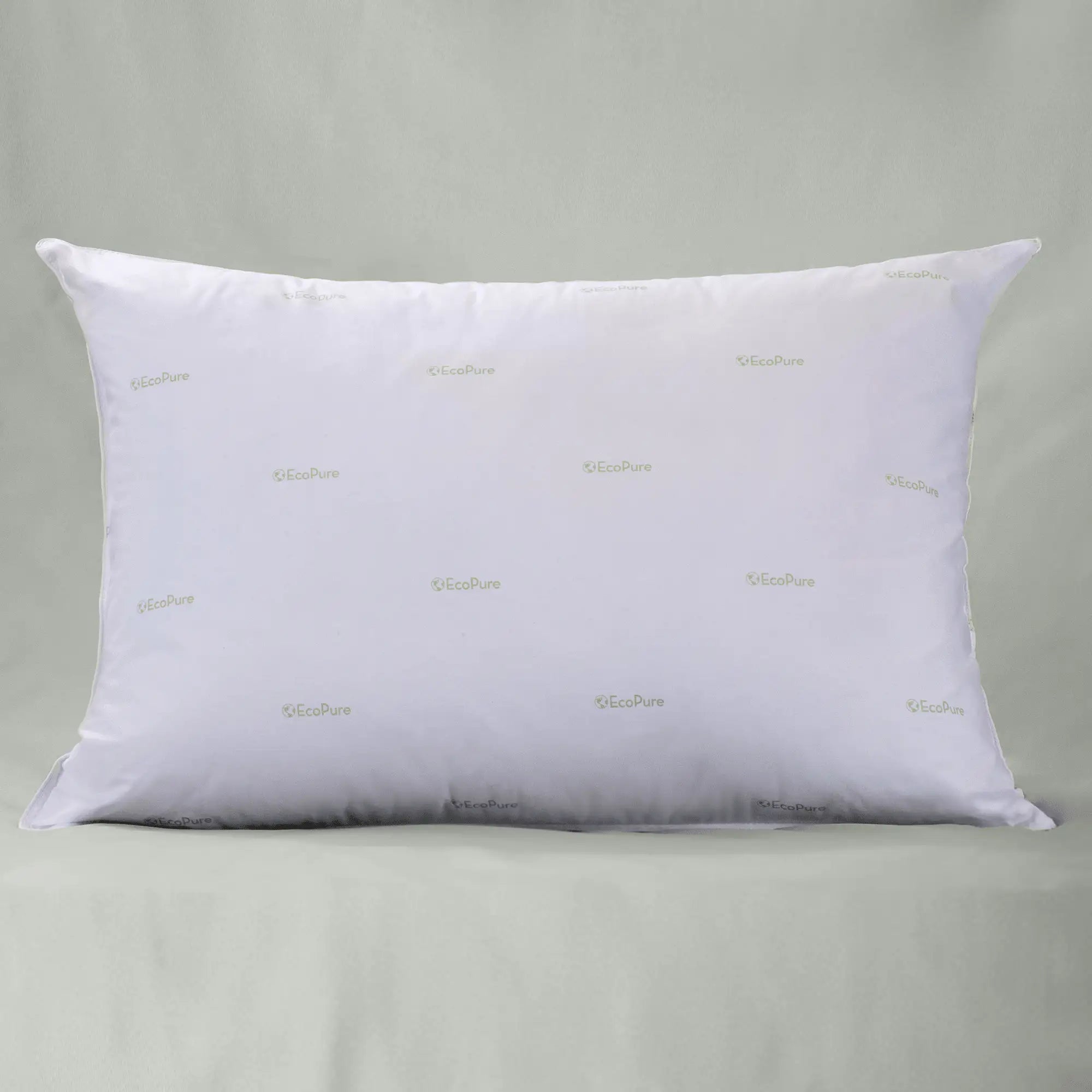 White pillow with embroidered text on a gray background