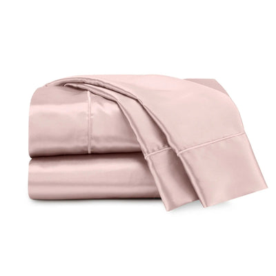 Folded pink bed sheets on a white background