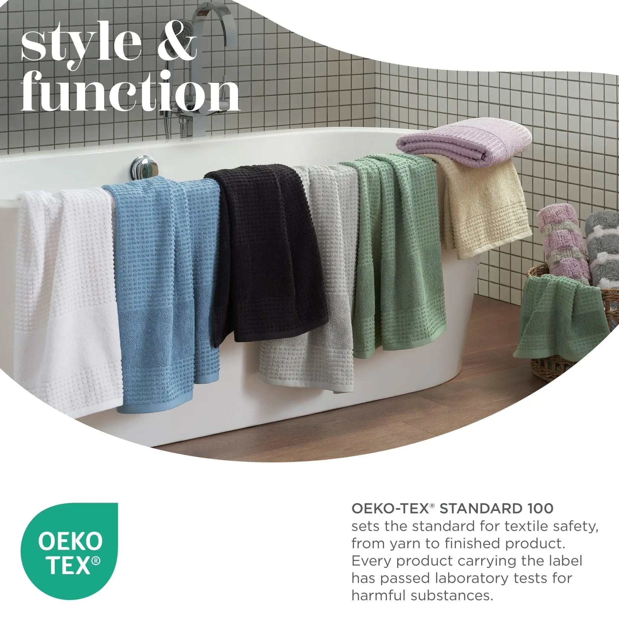 Colorful towels hanging over a bathtub with Oeko-Tex logo and text.