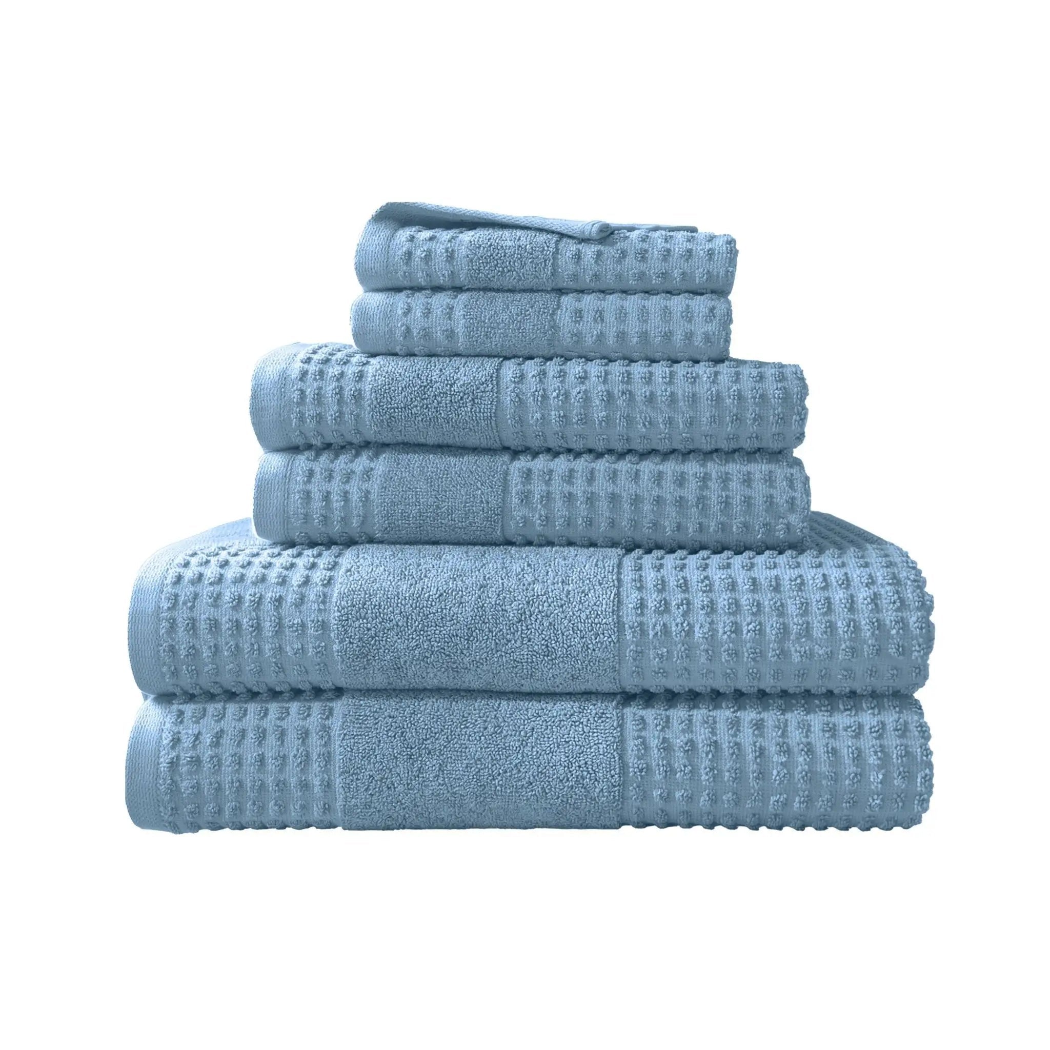 Set of blue towels with waffle texture on a white background