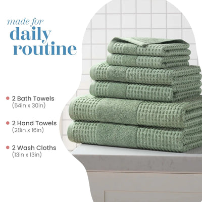 Stack of sage towel set on a toilet with product dimensions listed.