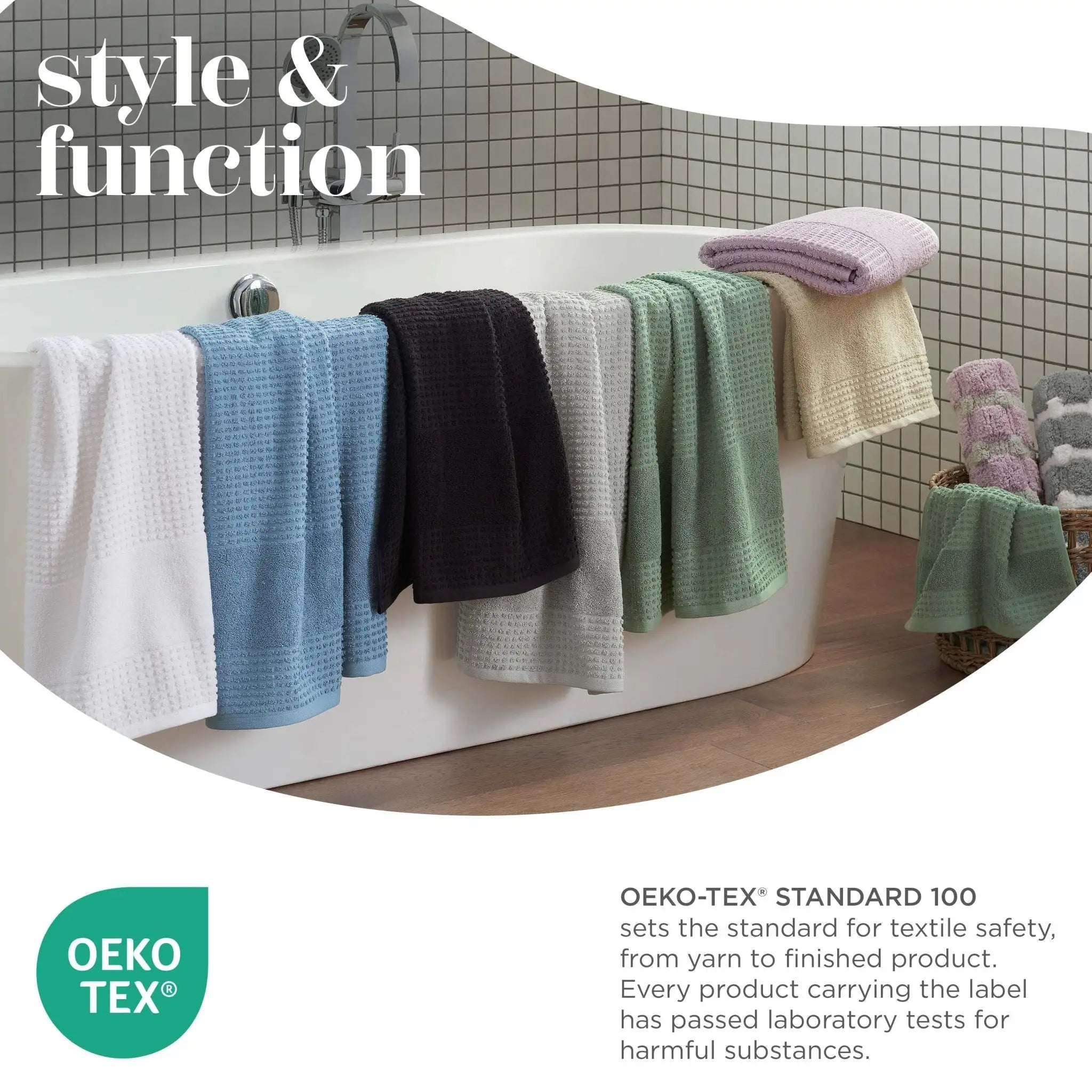 Colorful towels hanging over a bathtub with Oeko-Tex logo and text.