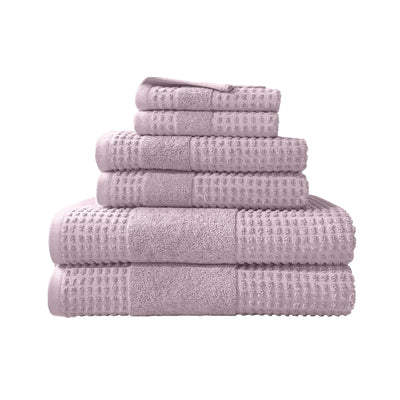Stack of lilac towels on a white background