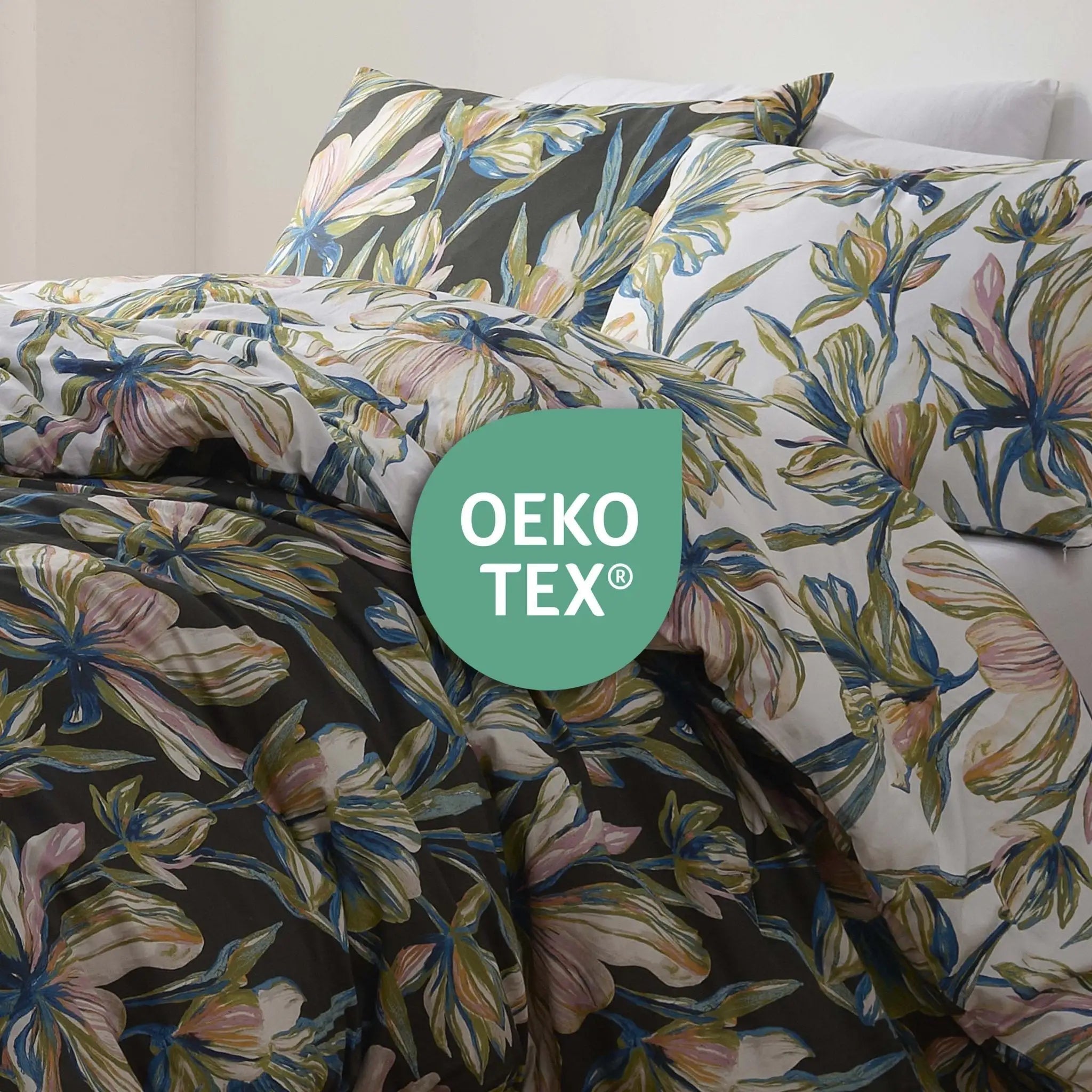 Floral bedding set on a bed with an OEKO-TEX logo overlay.