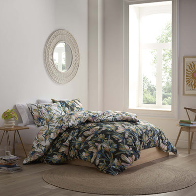 Bedroom with floral comforter set.