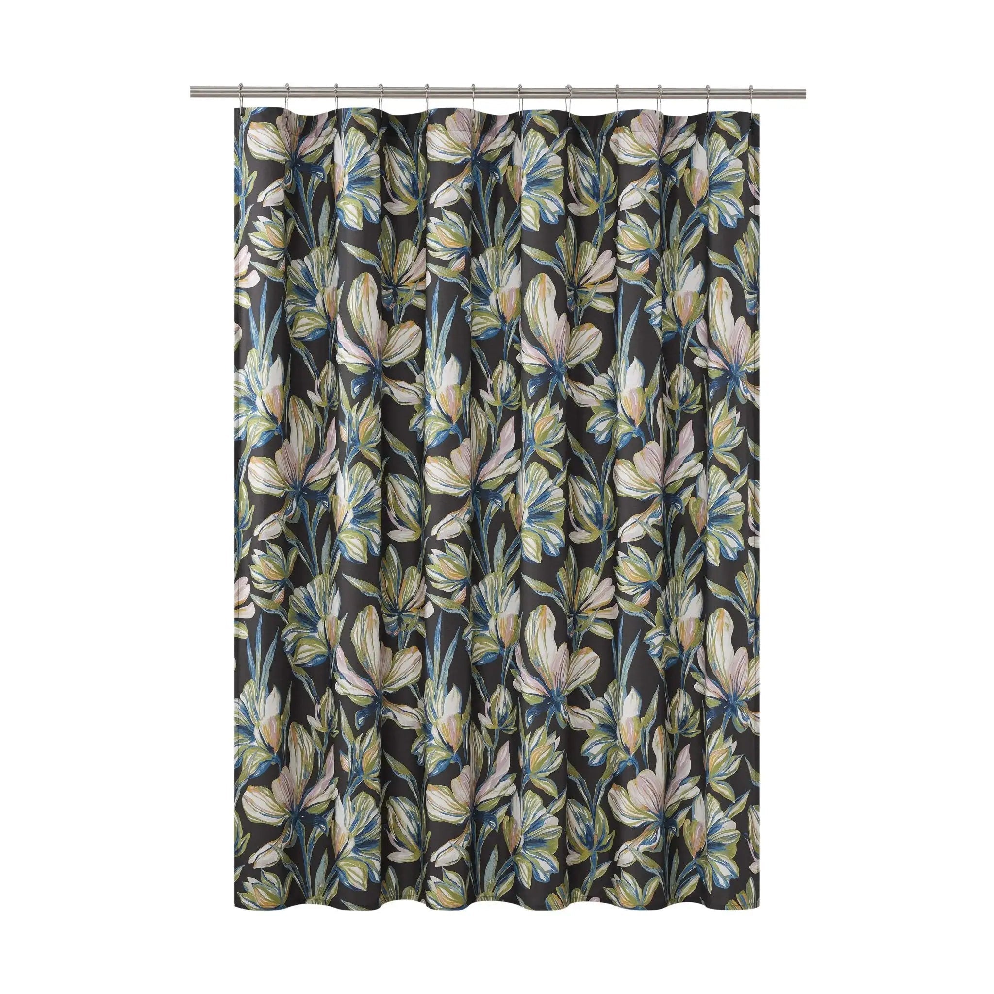 A shower curtain featuring an all-over botanical floral pattern with cream, beige, and light blue flowers on a dark charcoal background, hanging from a silver metal rod against a plain white studio background.