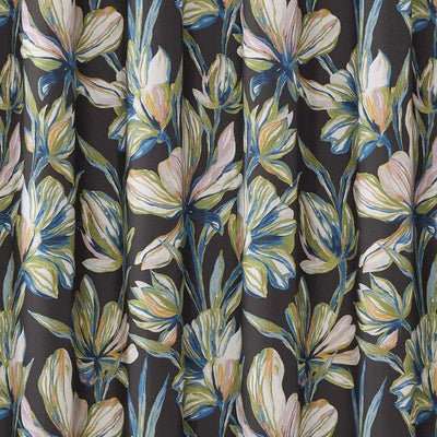A close-up of a dark charcoal gray curtain or fabric panel featuring a watercolor-style floral print with cream, light blue, and soft yellow flowers and leaves.