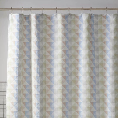Shower curtain with geometric triangle pattern on a plain background