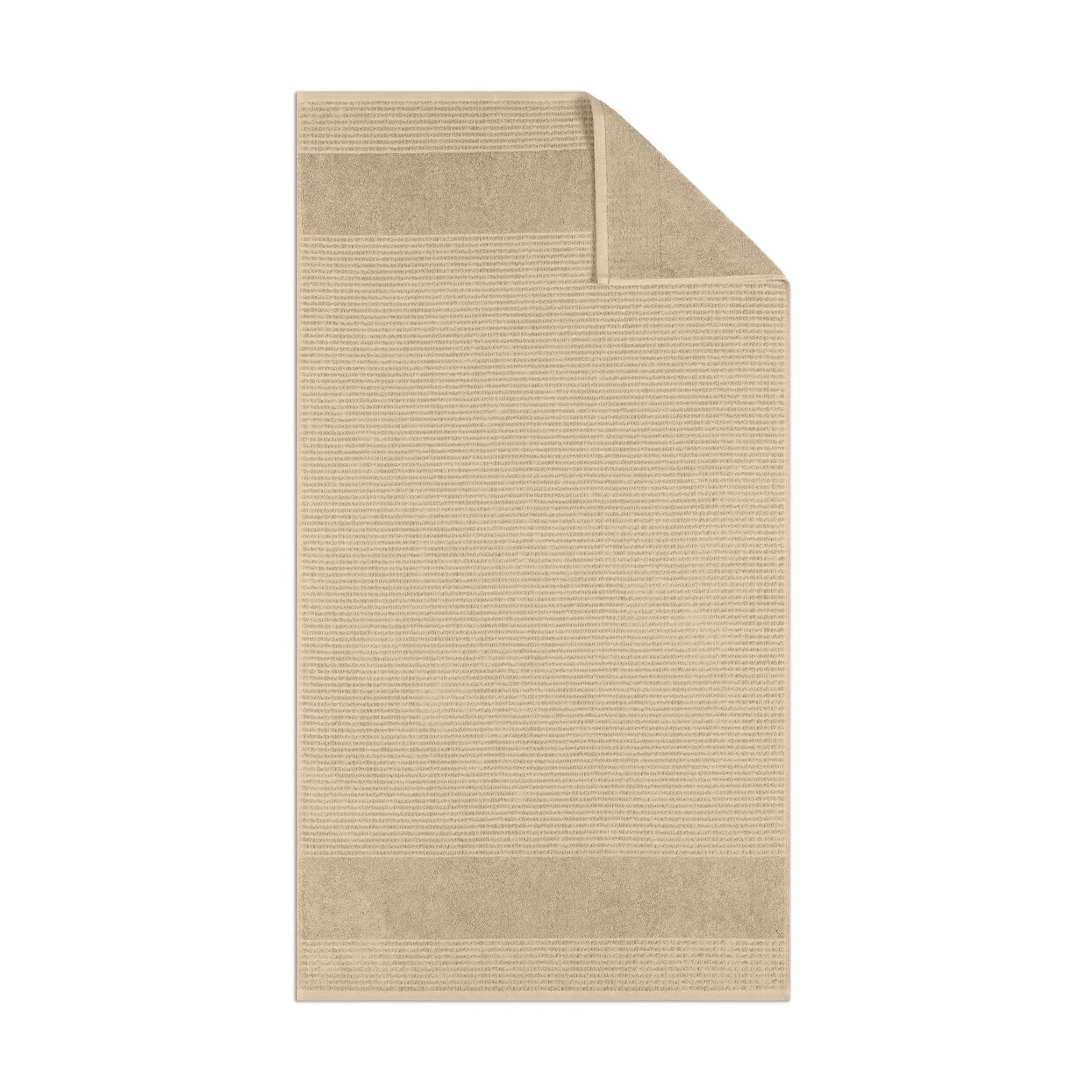 Sand color textured bath towel fabric on a white background