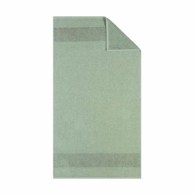 Sage textured bath towel fabric on a white background