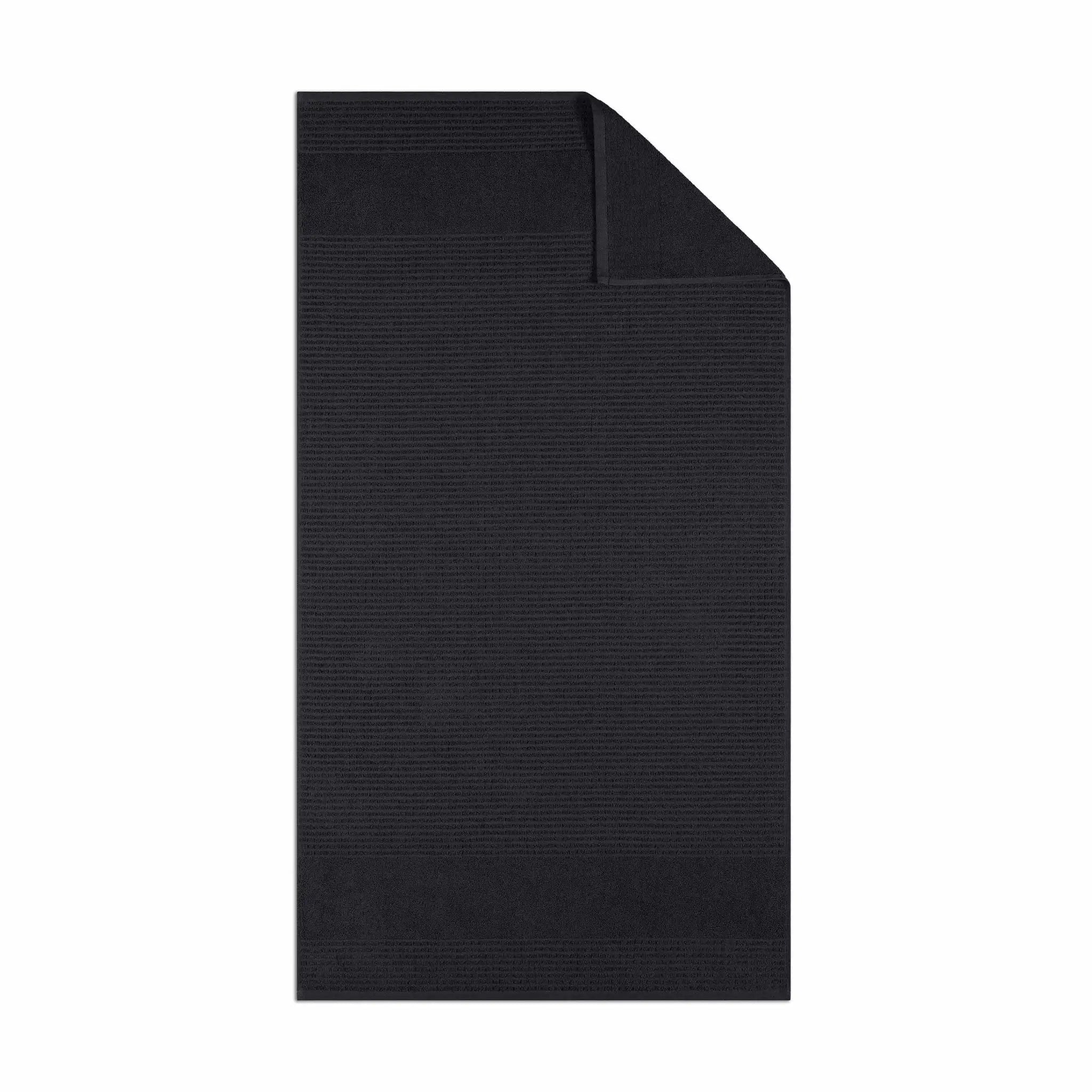 Black textured bath towel fabric on a white background