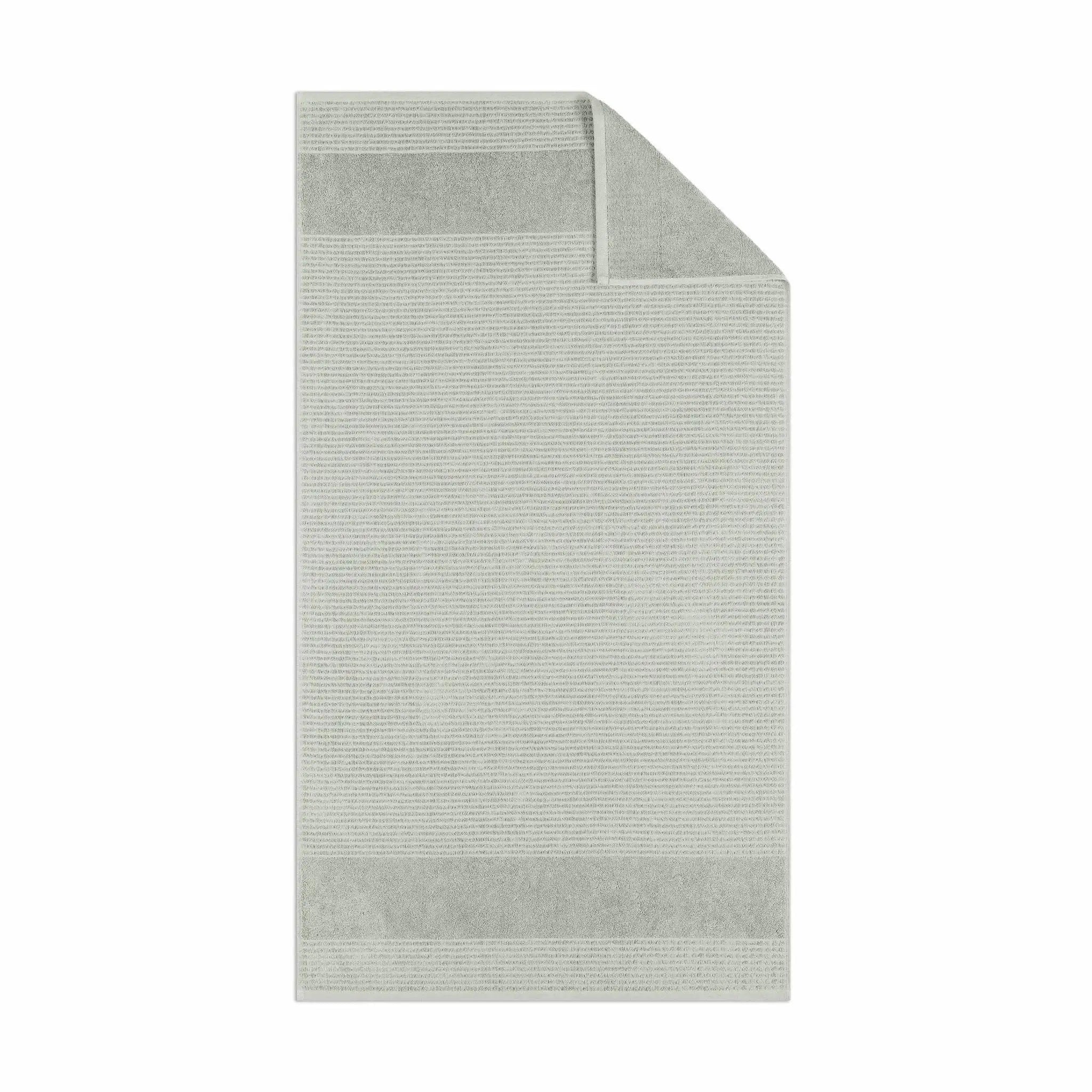 Grey textured bath towel fabric on a white background