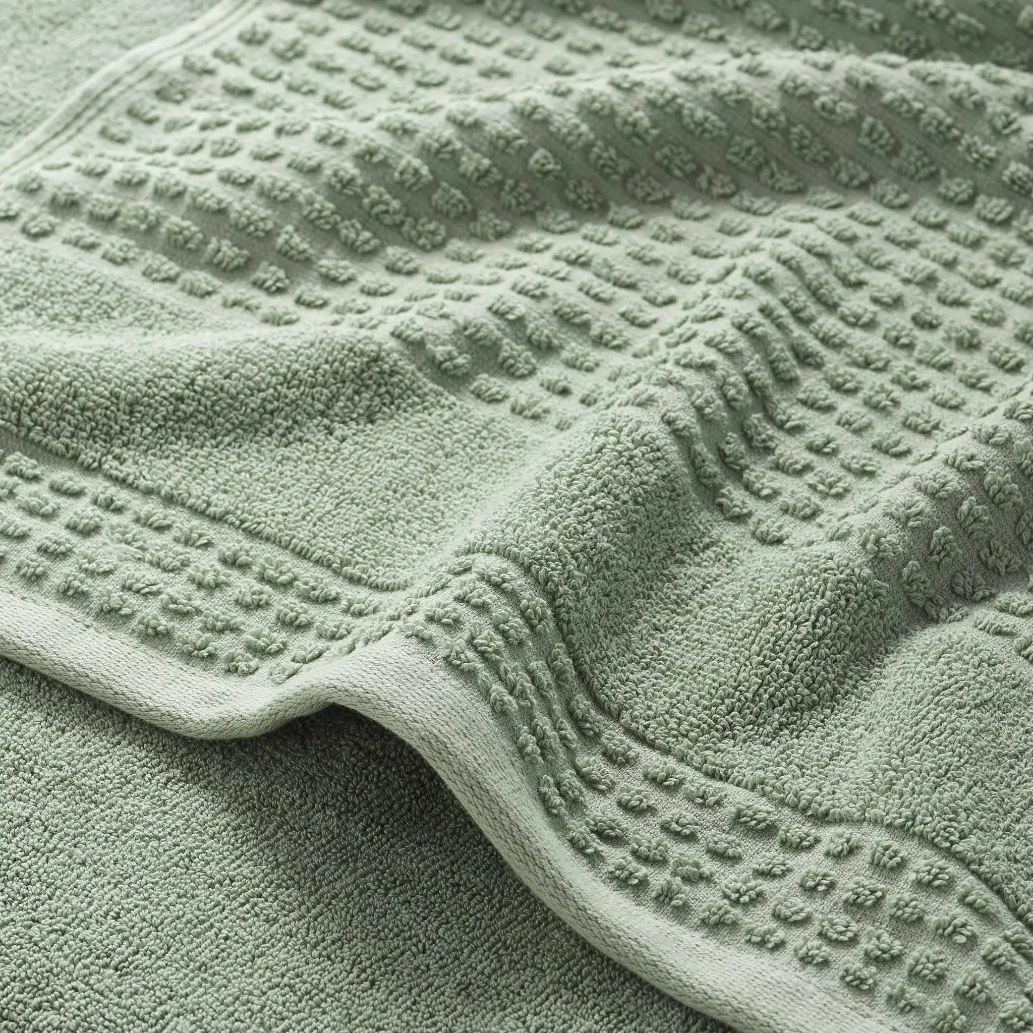 Close-up of a textured sage bath towel