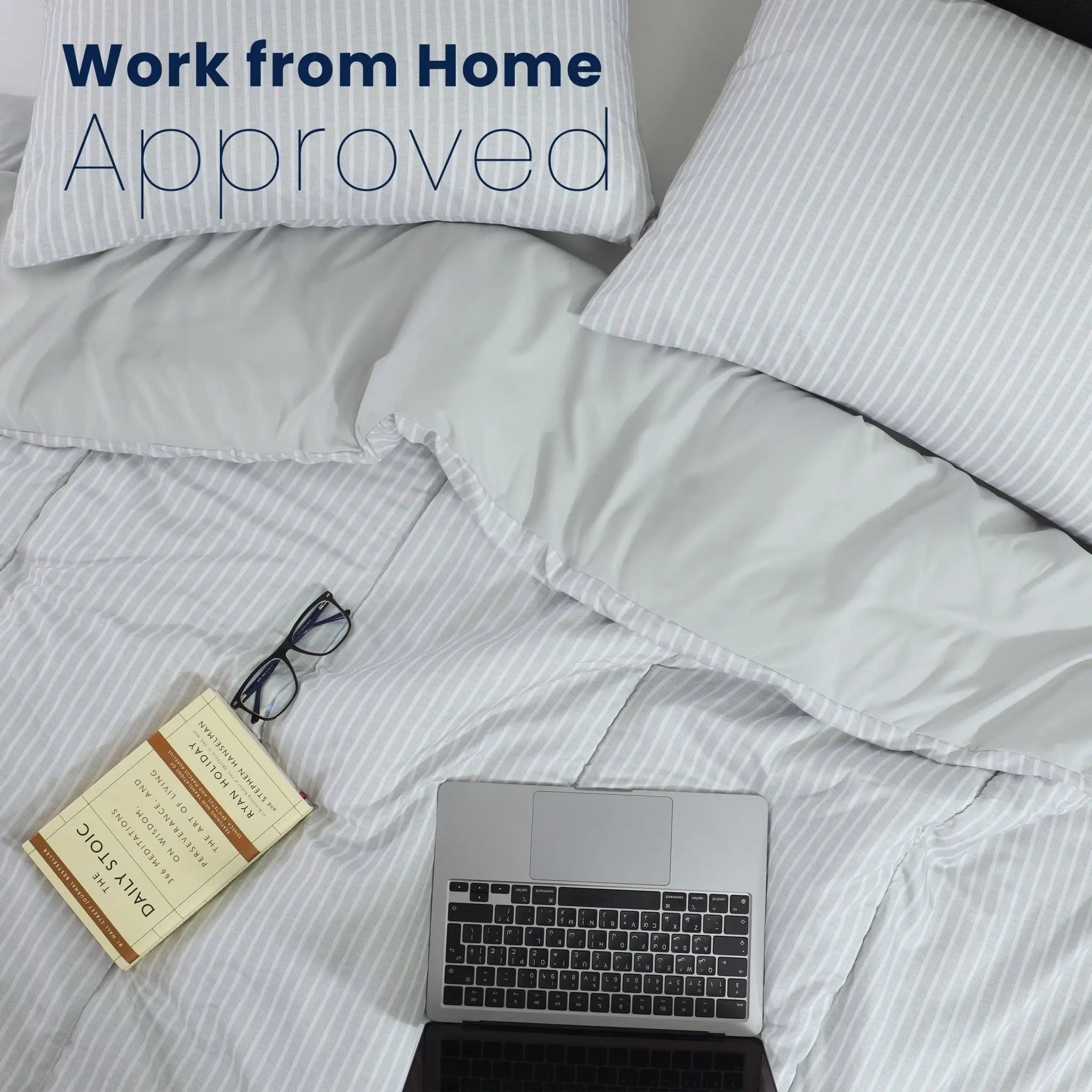 Laptop on a bed with 'Work from Home Approved' text above