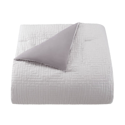 Gray comforter with a textured pattern on a white background