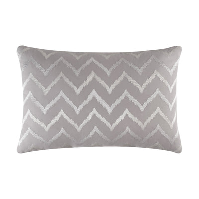 Gray pillow with white zigzag pattern on a white background