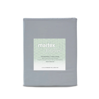 A folded gray bedding sheet set package with a white and pale green Martex Restore label, shown against a plain white background.