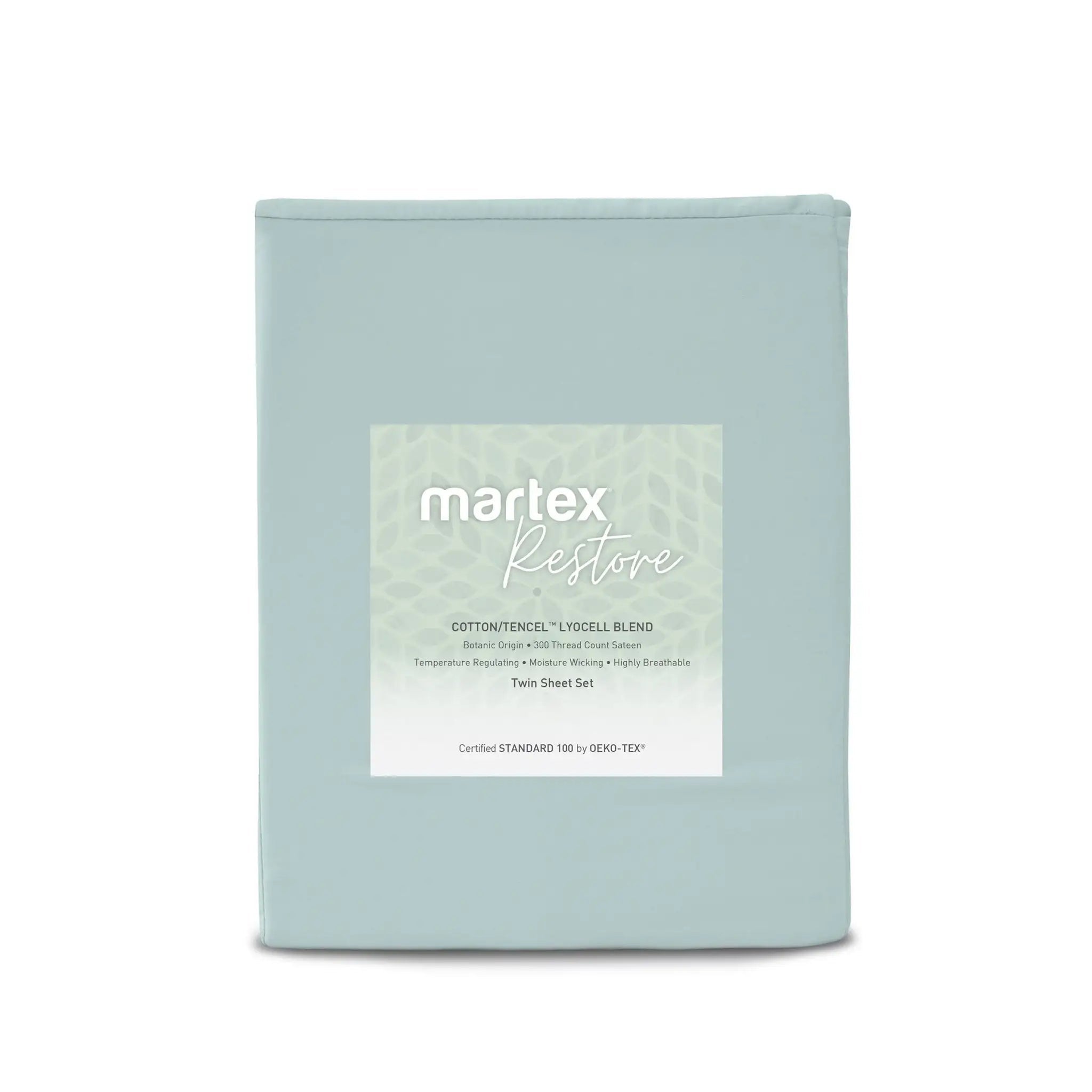 A light blue-green folded bedding sheet set in a soft sage green shade, featuring a white rectangular label in the center with the brand name 'martex' and product name 'Restore'.