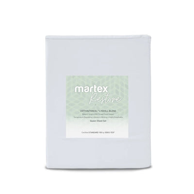 A folded white bedding sheet set package labeled 'martex Restore' with a pale green patterned label, photographed on a clean white background.