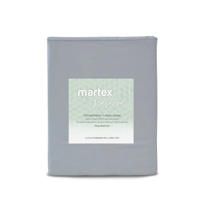 A folded gray bedding sheet set package with a white and pale green Martex Restore label, shown against a plain white background.