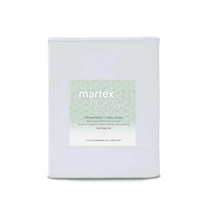 A folded white sheet set package labeled 'martex Restore' with a pale green patterned label, photographed on a clean white background.
