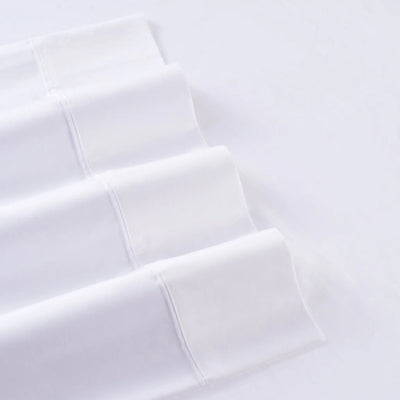 White folded fabric with a subtle woven texture, arranged diagonally on a matching white background.