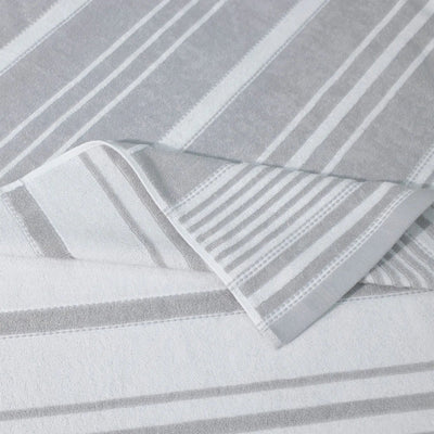 Close-up of gray striped fabric with a folded corner