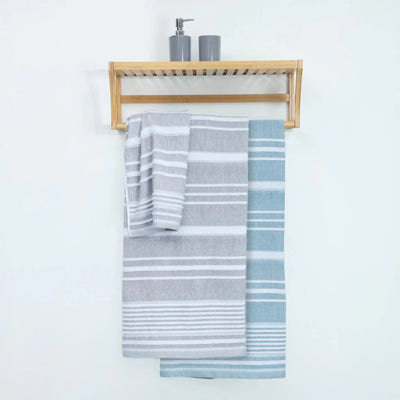 A light wood wall-mounted towel rack with two striped towels hanging below: one gray and one mineral.