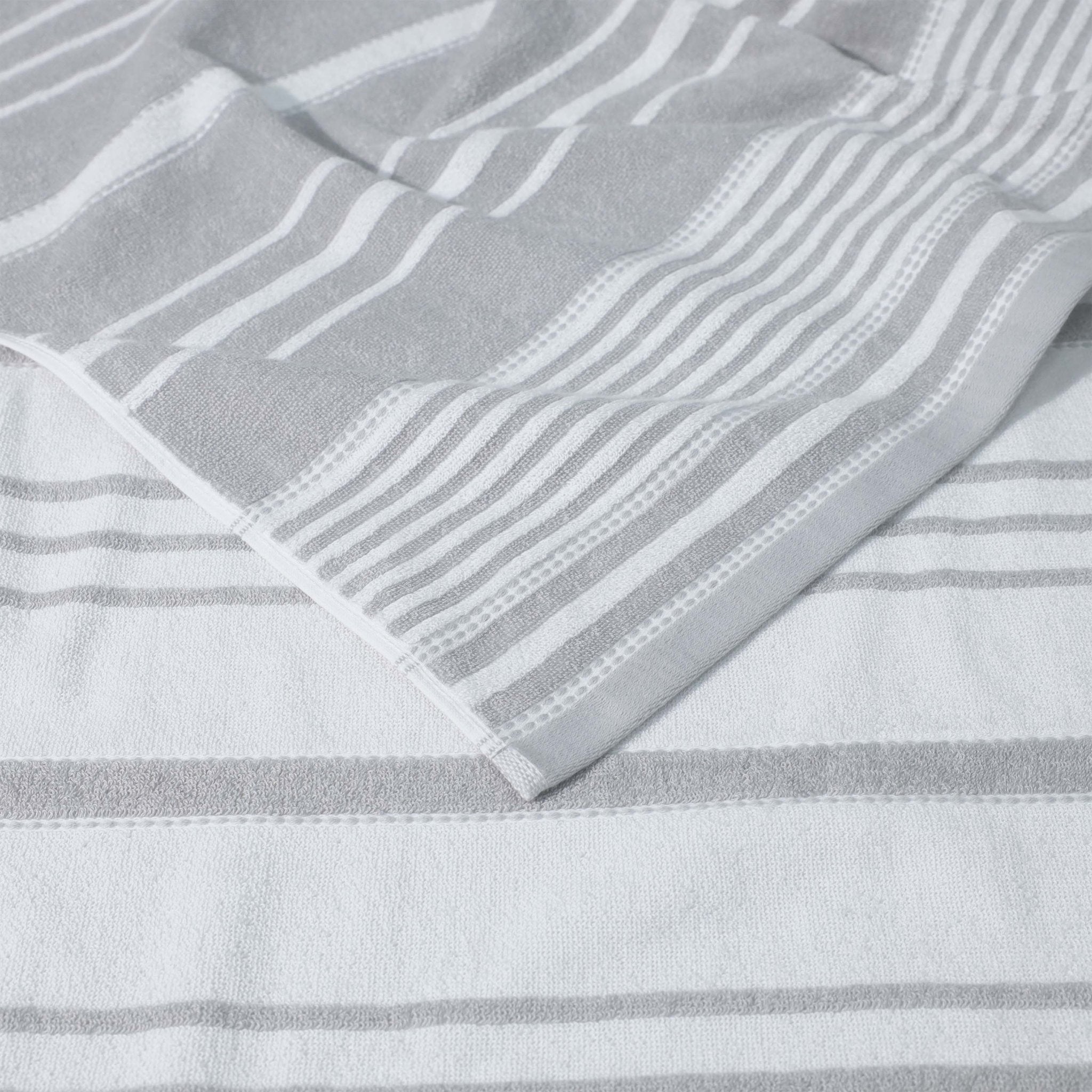 Close-up of a gray and white striped fabric with a textured pattern.