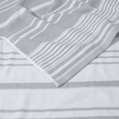 Close-up of a gray and white striped fabric with a textured pattern.