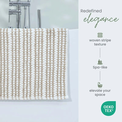 A close-up of a woven sand bath rug draped over the edge of a white bathtub.