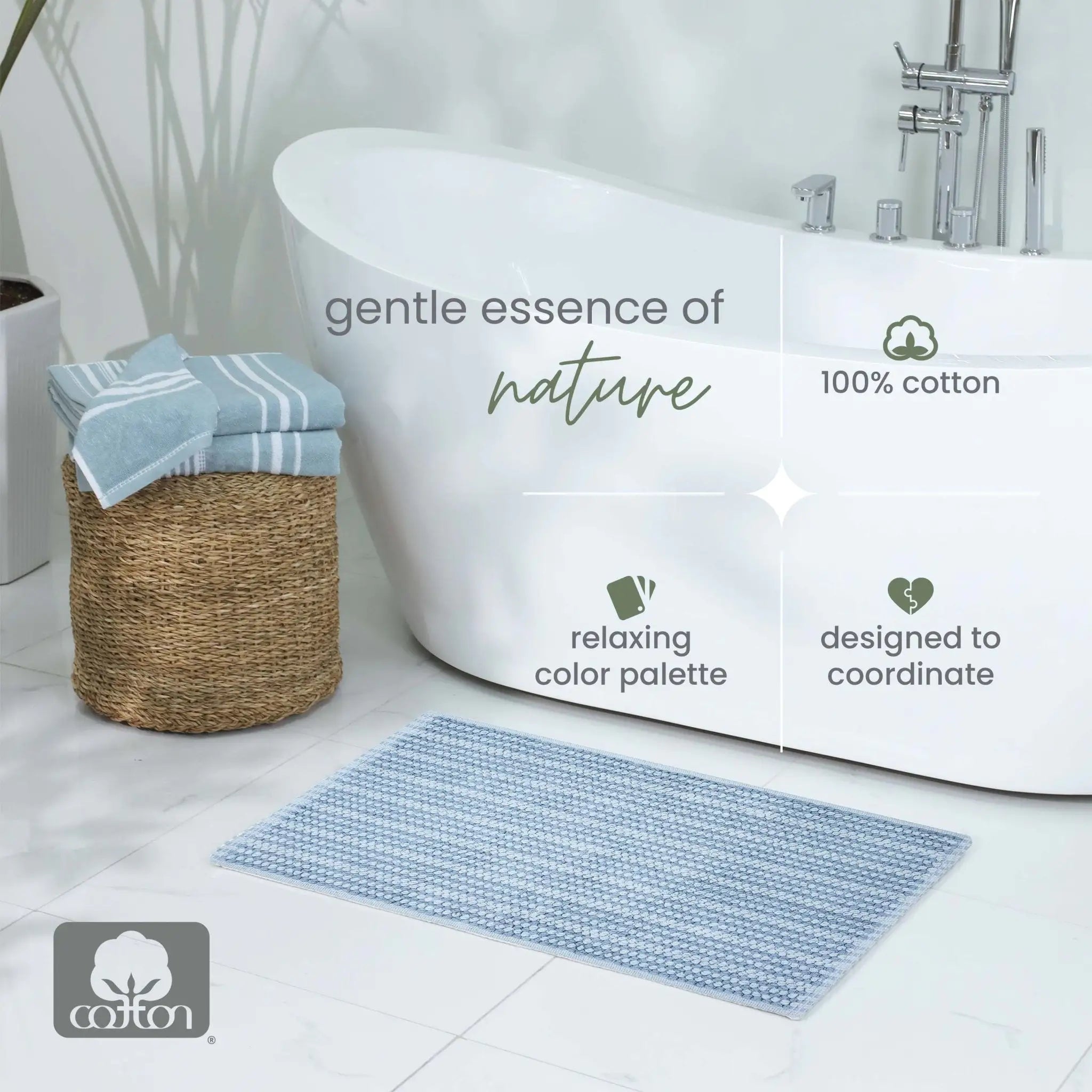 A blue bath mat in a bright bathroom setting next to a white freestanding bathtub, with overlaid text reading 'gentle essence of nature', '100% cotton', 'relaxing color palette', and 'designed to coordinate'.