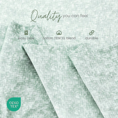 Mint green patterned fabric shown in soft folds with overlaid marketing text reading 'Quality you can feel,' plus small icons for easy care, cotton TENCEL blend, and durable. An OEKO-TEX badge appears in the lower left.