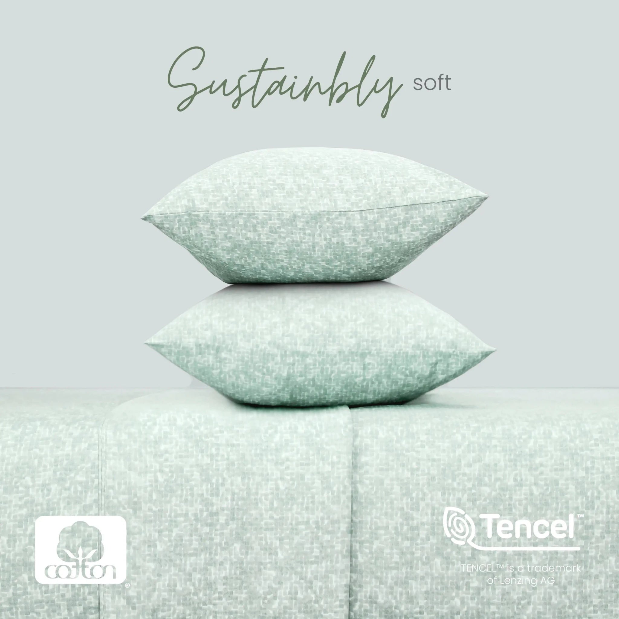 Two stacked square pillows in a pale mint green textured fabric, displayed on a matching upholstered surface against a light gray background. The words 'Sustainably soft' appear above, with cotton and TENCEL logos at the bottom.