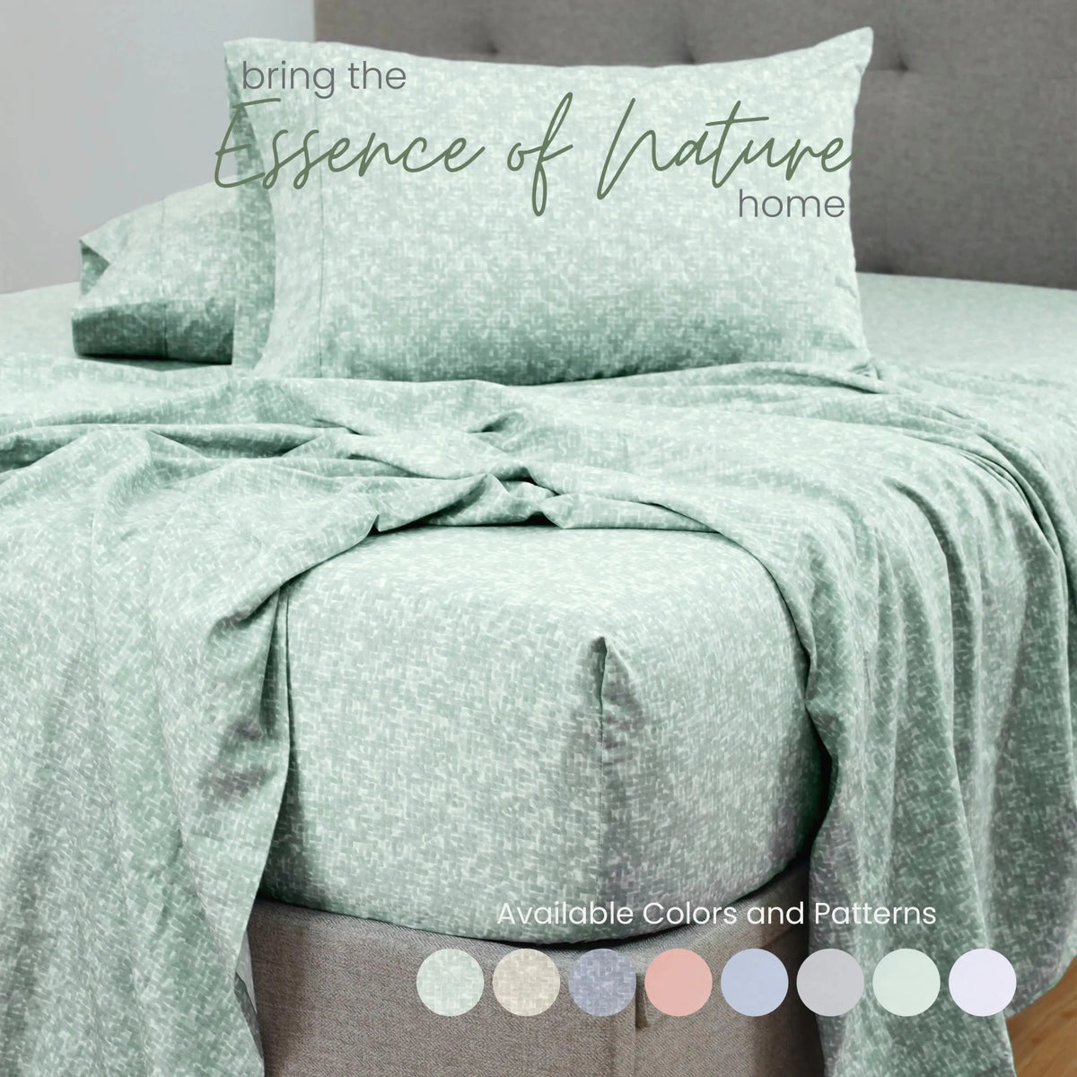 Green patterned bedding set on a bed with a gray headboard.