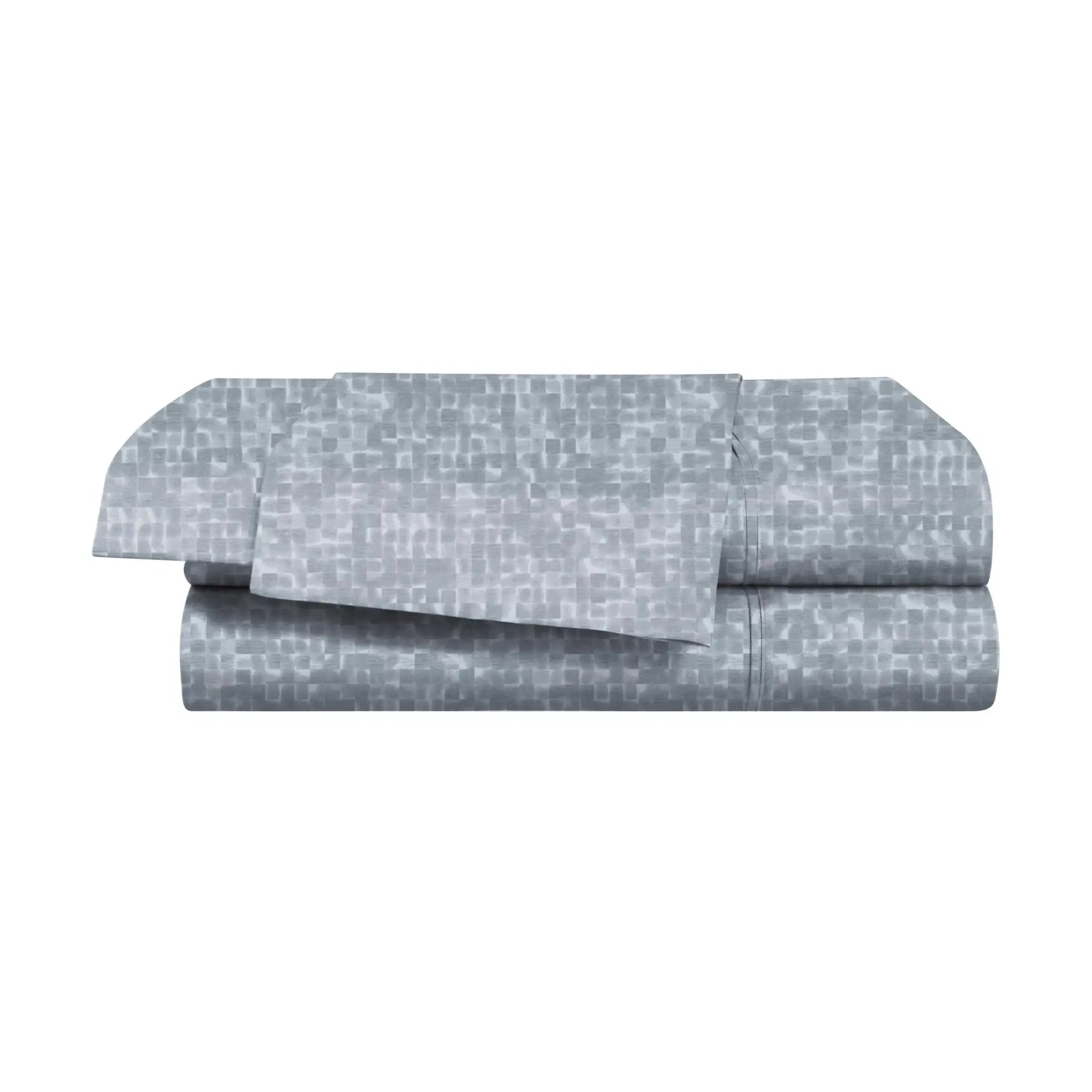 Folded blue bed sheets with a subtle pattern on a white background