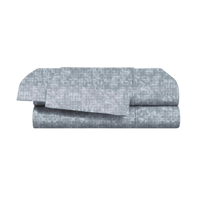 Folded blue bed sheets with a subtle pattern on a white background