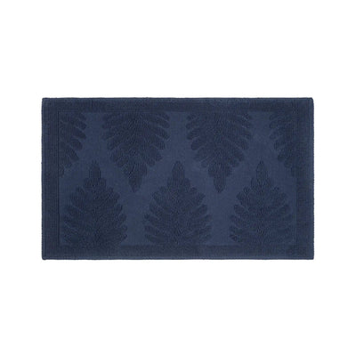A rectangular navy-blue bath rug featuring a raised embossed leaf pattern, shown flat against a solid white background.