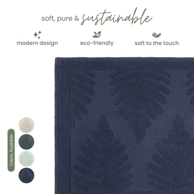 A close-up of a textured navy rug with a raised leaf pattern, shown on a white background with marketing text and color swatches.