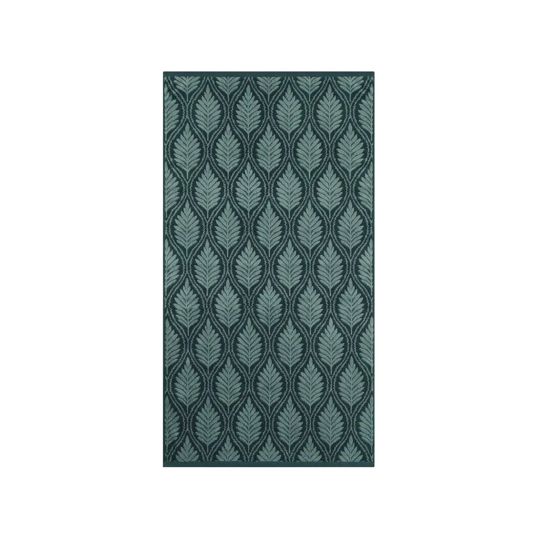 A jade bath towel with vertical leaf pattern in shades of teal and dark green, shown flat against a solid white background.