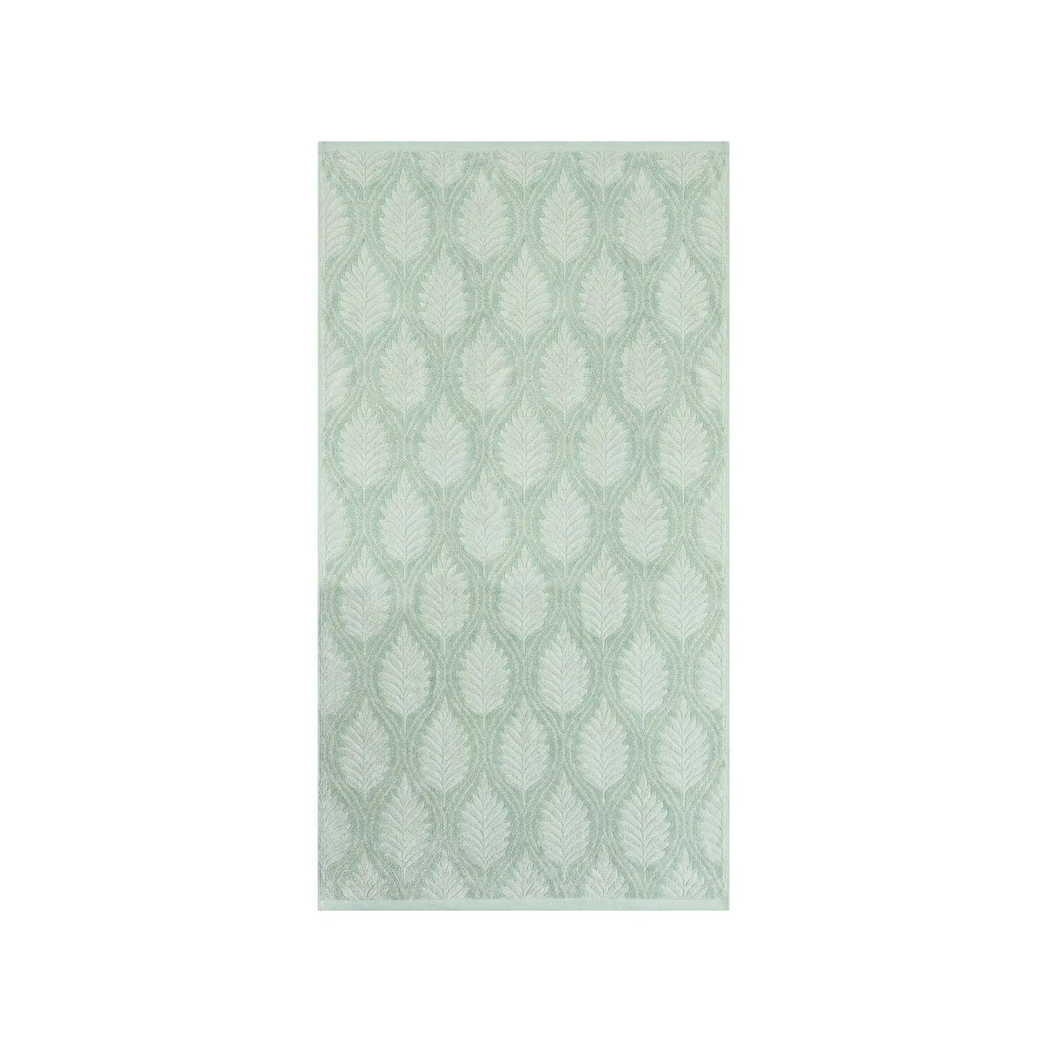 A sage bath towel with leaf pattern in sage green and white, shown flat against a solid white background.