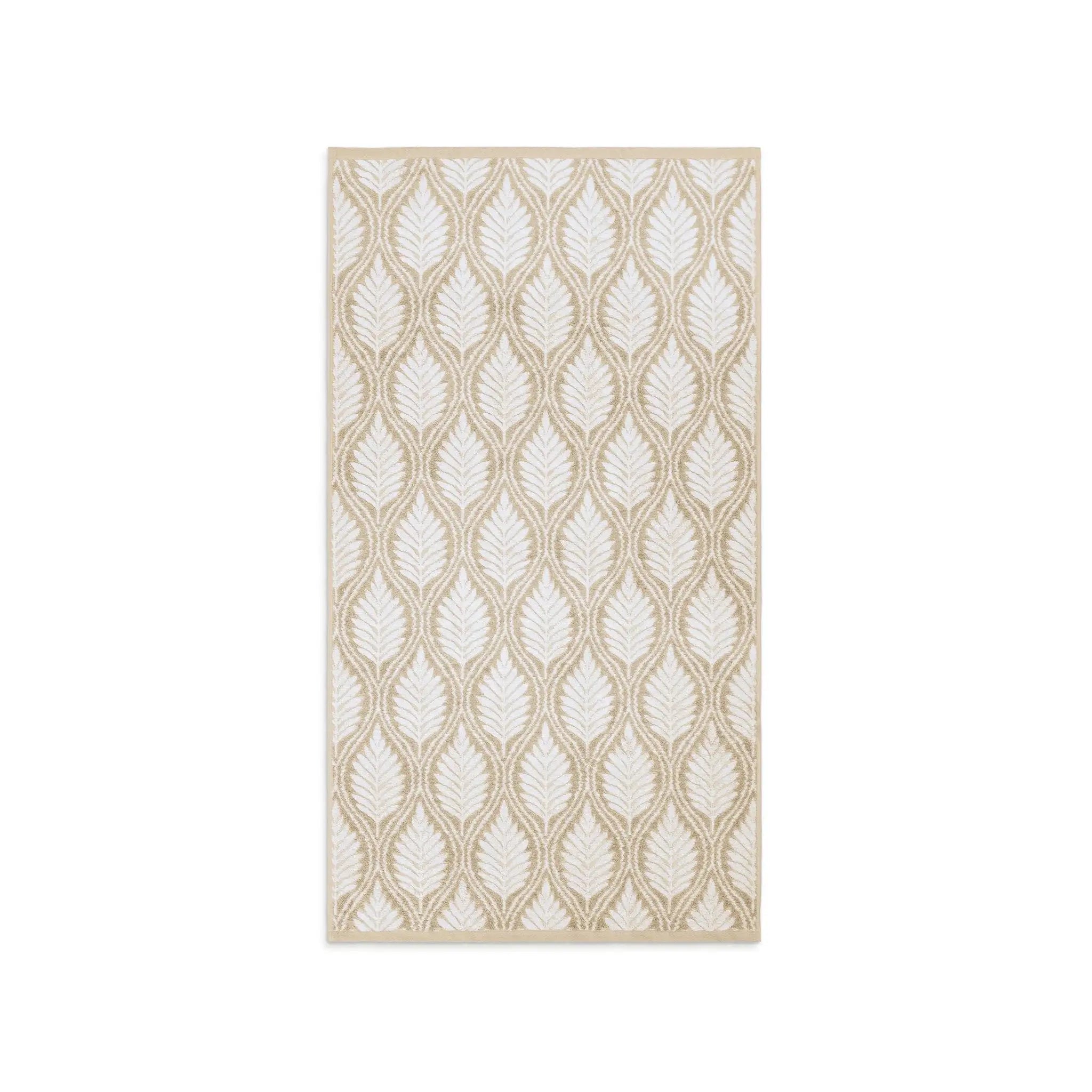A sand-colored bath towel leaf pattern in cream and beige, shown flat against a solid white background.