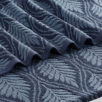 Close-up of a textured navy fabric with leaf pattern