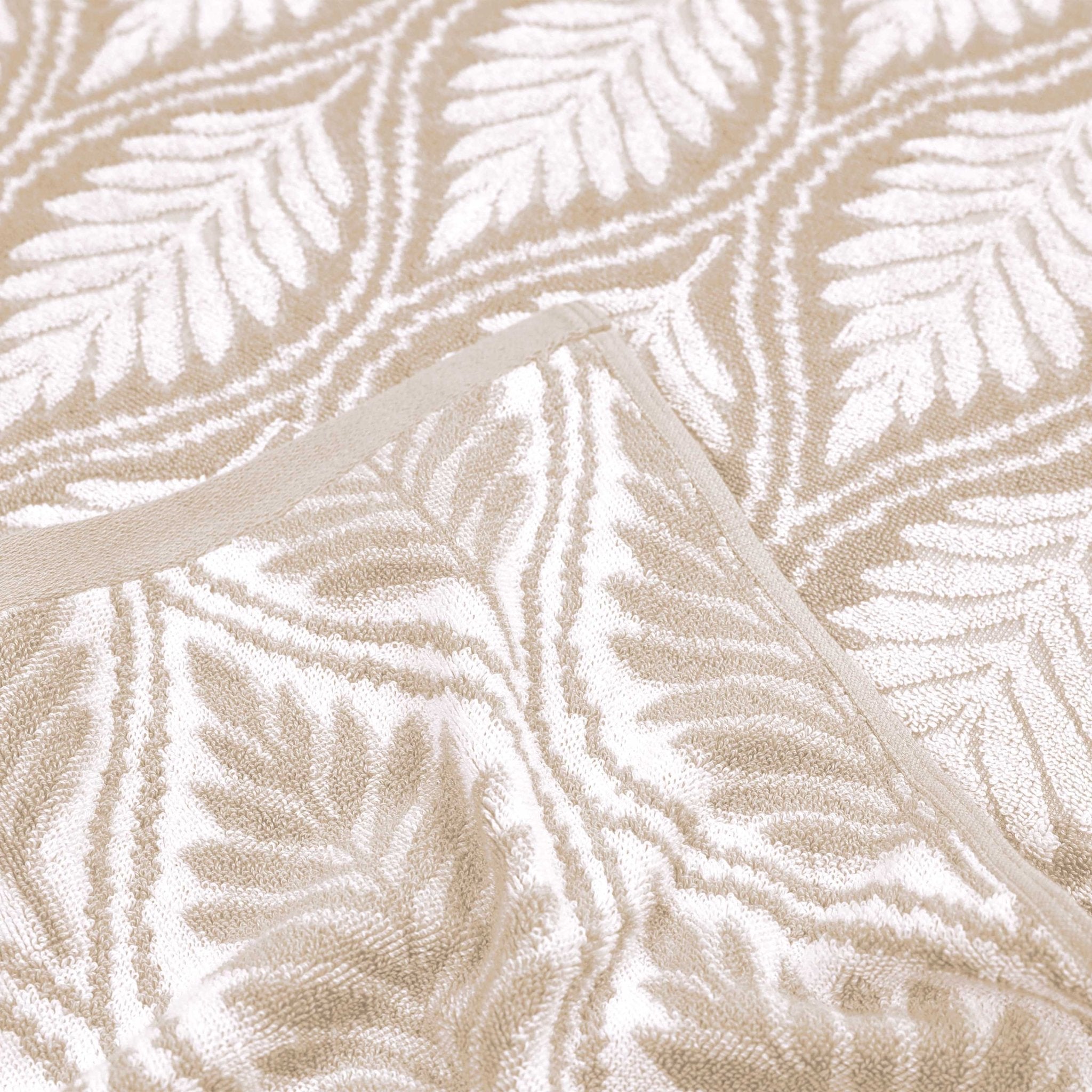 Close-up of sand textured fabric with leaf pattern in beige tones