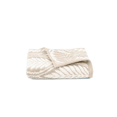 Folded textured sand towel on a white background
